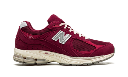 New Balance 2002R Bordeaux M2002RHA SneakerMood Side view, toe pointing right