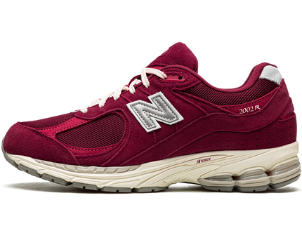 New Balance 2002R Bordeaux M2002RHA SneakerMood Side view, toe pointing left