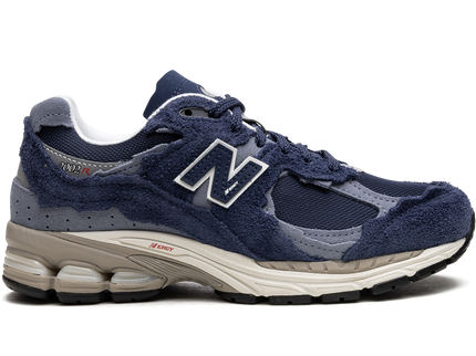 New Balance 2002R Protection Pack Navy Grey M2002RDK SneakerMood Side view, toe pointing right