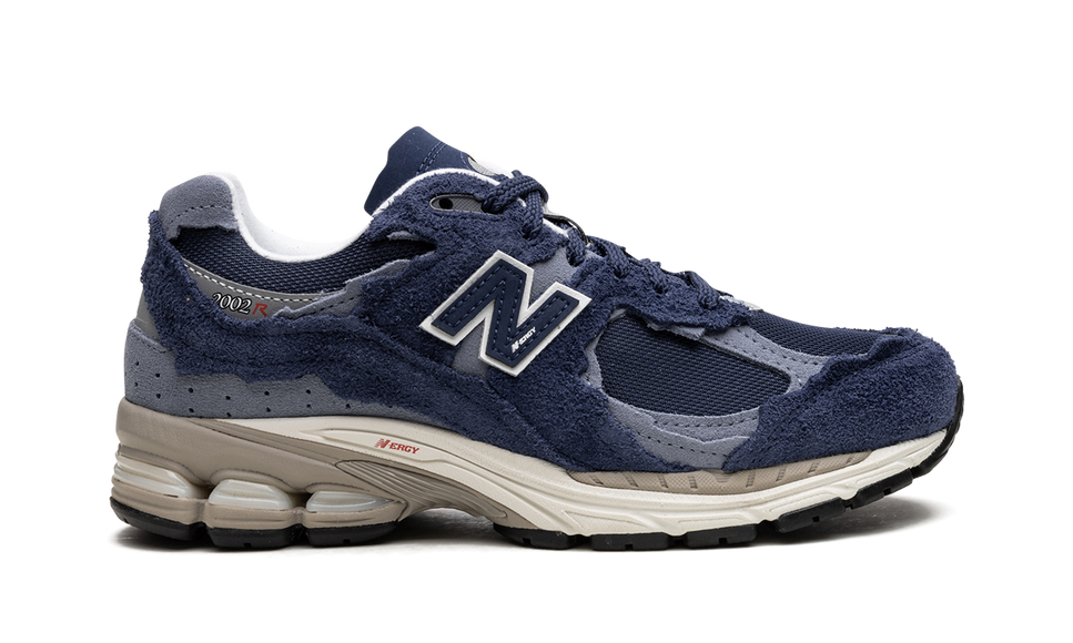 New Balance 2002R Protection Pack Navy Grey M2002RDK SneakerMood Side view, toe pointing right