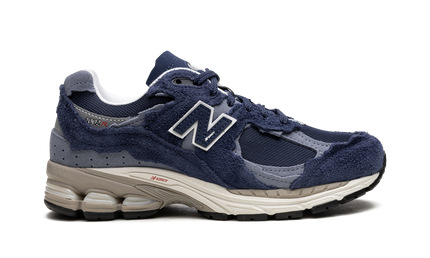 New Balance 2002R Protection Pack Navy Grey M2002RDK SneakerMood Side view, toe pointing right