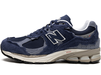 New Balance 2002R Protection Pack Navy Grey M2002RDK SneakerMood Side view, toe pointing left