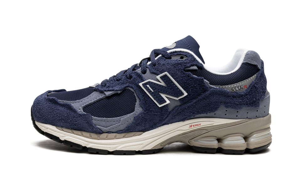 New Balance 2002R Protection Pack Navy Grey M2002RDK SneakerMood Side view, toe pointing left