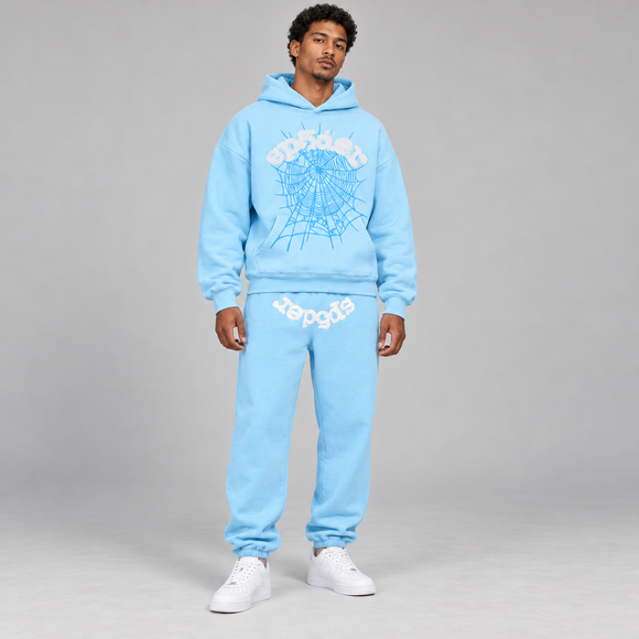 Sp5der Web Set Sky Blue – hoodie en sweatpants gedragen door een model in de studio